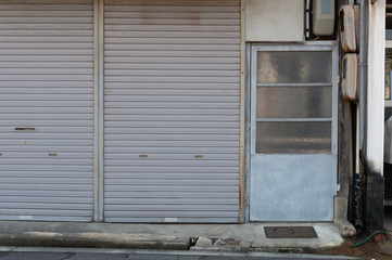 Fototapeta na wymiar sidewalk by street wall & door