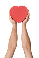 Male hand holding a red box in the shape of a heart. Isolate on white background