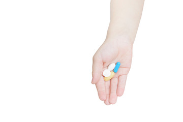 Tablets on a children's palm. Isolate on white background