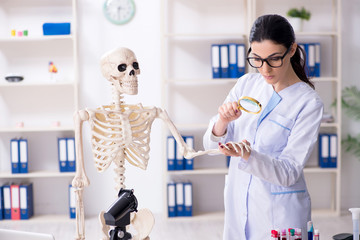 Young female archaeologist working in the lab 