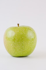 One single whole green apple isolated on white background