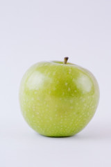 One single whole green apple isolated on white background