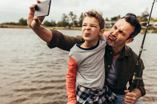 Man taking selfie with his kid outdoors