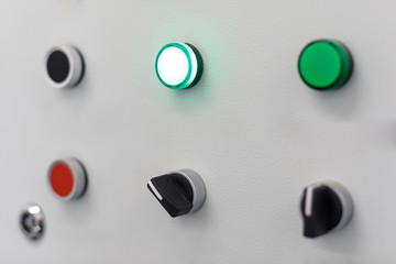 gray panel with red and a few green buttons and black switches