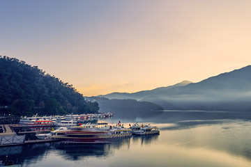 Fototapeta premium Nantou, Taiwan - December 8, 2018: Beautiful sunrise scenics of Sun Moon Lake with the surrounding mountains are the highlight at this sprawling lake at Yuchi, Nantou in Taiwan.
