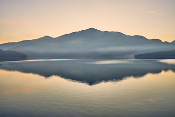 Beautiful sunrise scenics of Sun Moon Lake with the surrounding mountains are the highlight at this sprawling lake at Yuchi, Nantou in Taiwan.