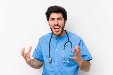 Surgeon doctor man over isolated white wall unhappy and frustrated with something
