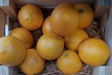 Detail shot of oranges in a wooden shelf