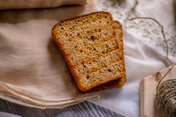 appetizing peace of healthy homemade bread on light craft background