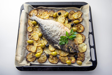 Baked sea bream with potatoes and olives