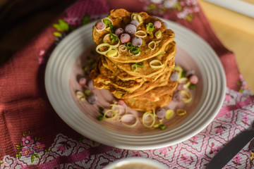 tasty breakfast in bed from eastern pancakes and Masala tea, served on the wood folding breakfast table