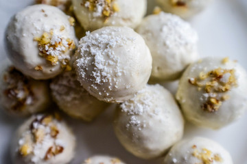 tasty homemade pumpkin candy balls in white chocolate topping of nut crumbs