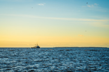 Fototapeta na wymiar Lobster fishing boat scenery of Canada's Atlantic coast with a beautiful sky.