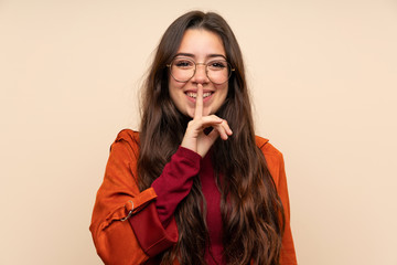 Teenager girl with coat doing silence gesture