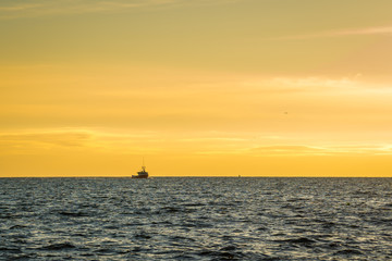 Fototapeta na wymiar Lobster fishing boat scenery of Canada's Atlantic coast with a beautiful sky.
