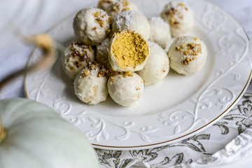 tasty homemade pumpkin candy balls in white chocolate topping of nut crumbs