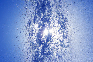 drops of the fountain in the setting sun