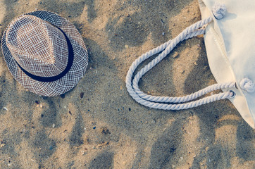 Fototapeta na wymiar Hat and beach bag are on the sand