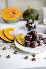 tasty homemade pumpkin candy balls in dark chocolate topping of coconut crumbs