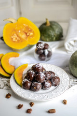 tasty homemade pumpkin candy balls in dark chocolate topping of coconut crumbs