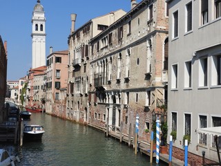 Fototapeta na wymiar Beautiful Venetian street and canals on a summer day, Italy
