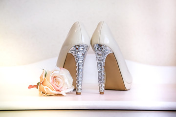 Wedding shoes beige high-heeled stand on the dresser