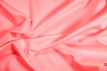 Closeup of rippled coral satin fabric