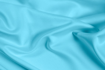 Closeup of rippled light blue satin fabric