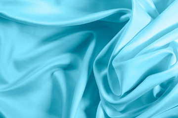 Closeup of rippled light blue satin fabric
