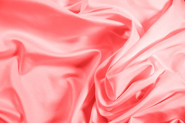 Closeup of rippled coral satin fabric