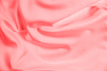 Closeup of rippled coral satin fabric