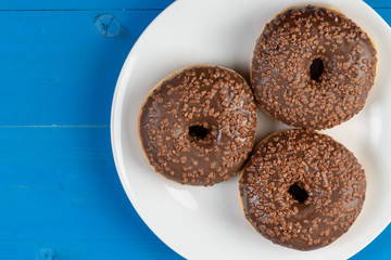 Donut With Chocolate Topping Cream On The Blue Background