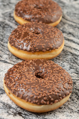 Donut With Chocolate Topping Cream On The Grey Marble