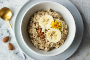 oatmeal porridge with banana and almond, top view