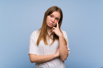 Young woman over blue wall looking to the front