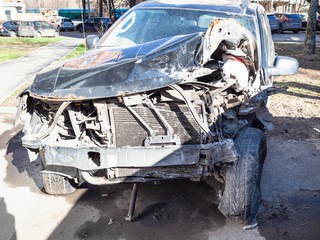 crashed car on city street