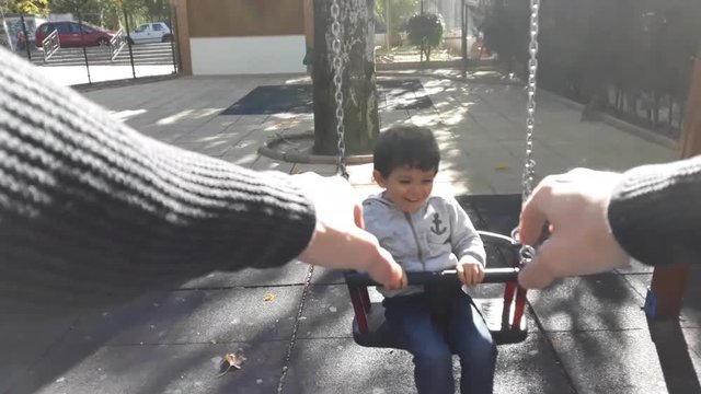 Man Playing In Swing With Little Kid, Phone First Person Video