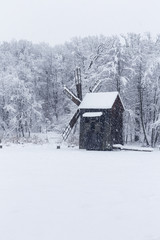 Windmill in Village Museum during snowy winter - 263282224