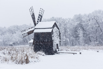 Windmill in Village Museum during snowy winter - 263282227
