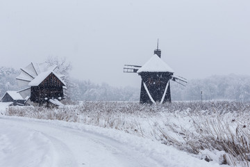 Windmills in Village Museum during snowy winter - 263282237