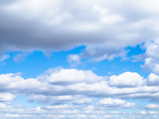 low cumulus clouds in blue sky