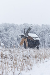Windmill in Village Museum during snowy winter - 263282255