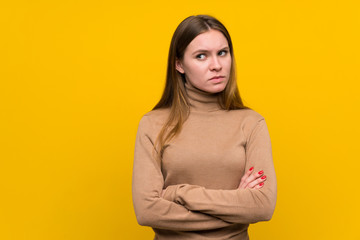 Young woman over colorful background standing and thinking an idea