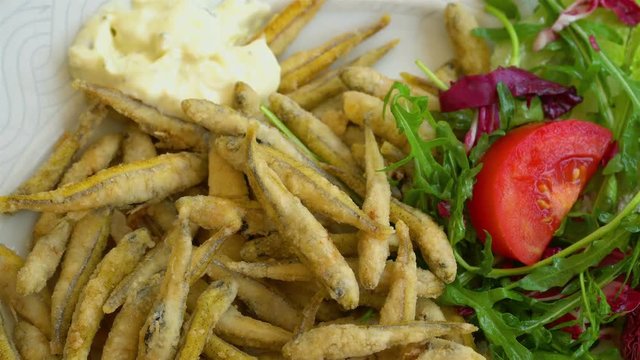 Grilled and fried seafood on a traditional Mediterranean plate garnished with summer vegetables and fruits - greece, croatia, italy, montenegro, squid.