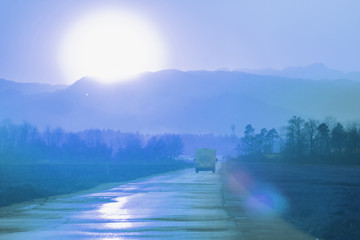 evening road heading to beautiful blue toned sunset horizon