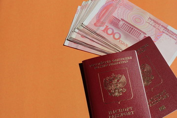 Biometric russian passport and yuan. Tourism, travel and international relations concept.