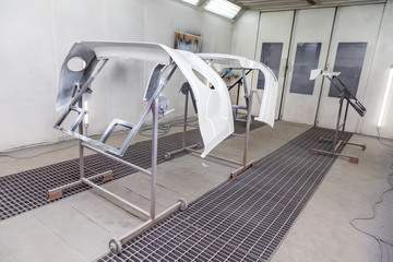 Painting and drying in professional box of car body parts after applying putty and paint on bumper...