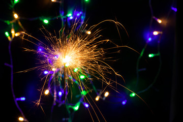 sparkler with blur new year's light close up