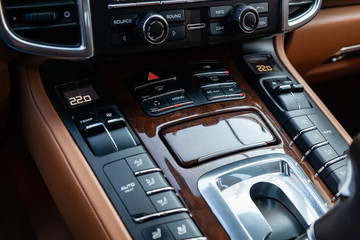 Obraz premium The interior of the car with a view of the climate-control, dashboard, seats and multimedia system with light brown leather trim