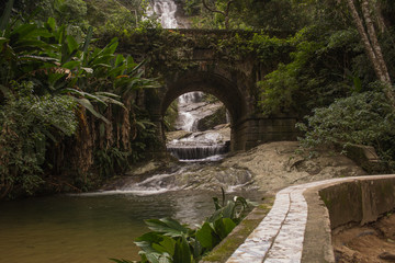 Rio de Janeiro, Brazil - April 19, 2019: Beautiful waterfall called "Cascatinha Taunayon" on green nature in the Atlantic Rainforest, Tijuca Forest National Park